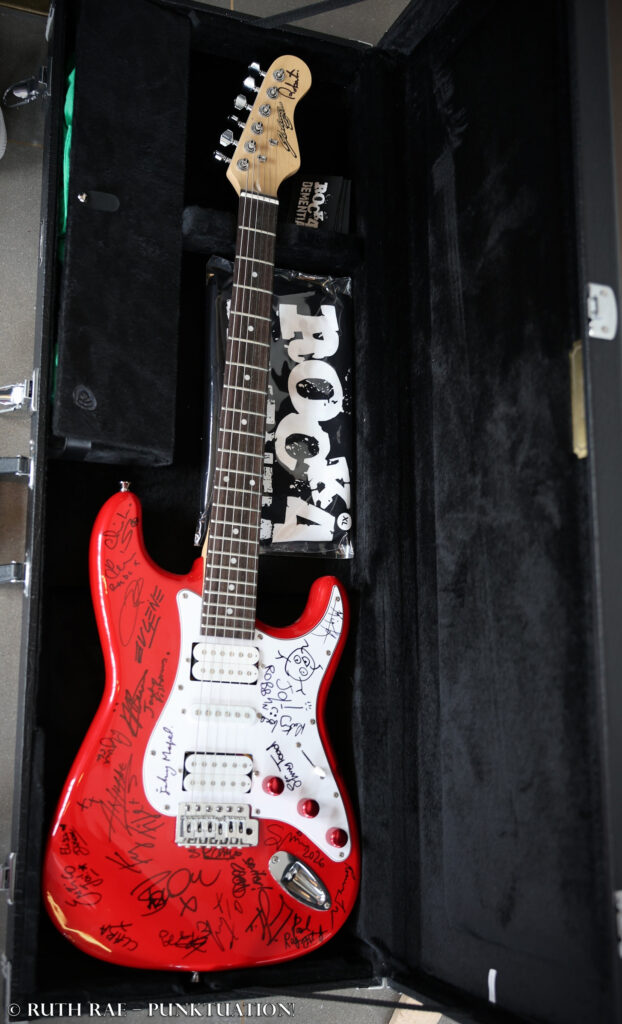 Signed guitar - Rebellion 2026 - photo © Ruth Rae